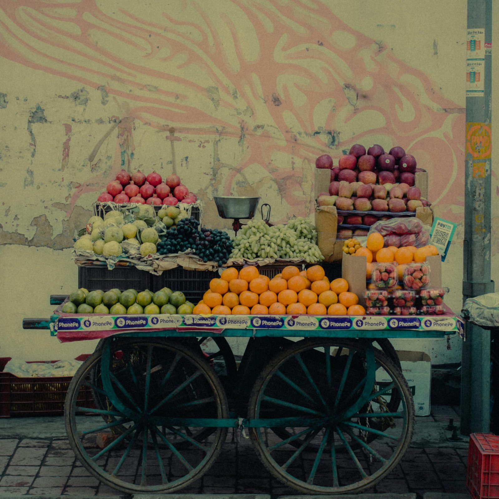 A lively street market fruit cart laden with colorful fresh fruits under soft light.